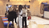 a group of people are standing in a room with a sign that says gma on it