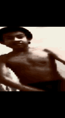 a man without a shirt is dancing in a blurry picture