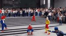 a group of mascots including spider man and woody woodpecker are performing in front of a crowd