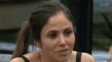a woman with her hair in a ponytail is looking at something