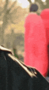 a close up of a person wearing a black jacket and a red jacket .