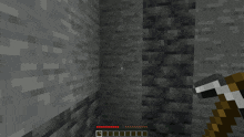 a screenshot of a minecraft game with a pickaxe in the foreground and a green item in the middle