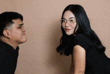 a man and a woman are looking at each other