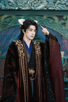 a man in a costume with ears on his head points up