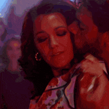a man kissing a woman 's neck in a close up