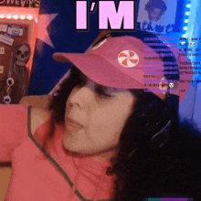 a woman wearing a pink hat and headphones says i 'm