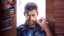 a drawing of a man with a beard is being drawn with colored pencils