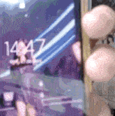 a person is holding a phone with the time of 14:57