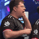 a man wearing a black shirt with the word steelseries on it