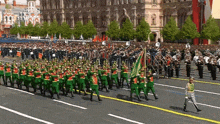 a large group of people marching in a parade with a flag that says ' russia ' on it