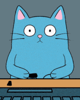 a blue cat is sitting at a desk with a keyboard