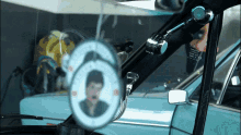 a car with a picture of a man in the rear view mirror