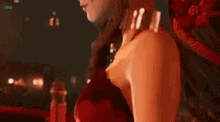a woman in a pink dress is standing next to another woman in a red dress .