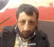 a man 's face is shown in a gif with the hashtag @koksalgif