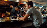 a man is sitting at a bar drinking a beer