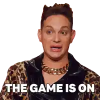 a man wearing a leopard print jacket and a gold chain necklace says the game is on