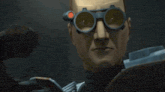 a man wearing a pair of goggles is smiling .