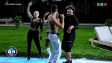 a group of people are dancing in front of a sign that says gh
