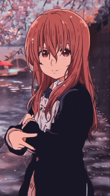 a girl with long red hair is holding a book in her hand