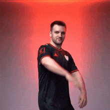 a man wearing a black adidas shirt is dancing