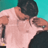 a person wearing a white t-shirt that says good latiny