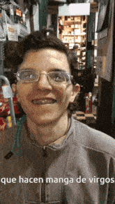 a man wearing glasses and braces is smiling and says que hacen manga de virgos on the bottom