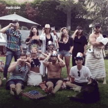 a group of people posing for a picture with marie claire in the upper right corner