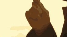 a close up of a person 's hand giving a thumbs up sign .