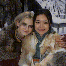 two women are posing for a picture and one has a scarf around her neck