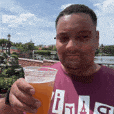 a man wearing a purple shirt with the letter i on it