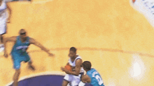 a basketball player wearing a number 5 jersey is dribbling the ball