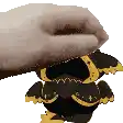 a hand is holding a stuffed animal that looks like a cartoon character .