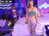 a woman is standing in front of a bed with a timer that says 3:52