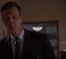 a man in a suit and tie is talking to someone