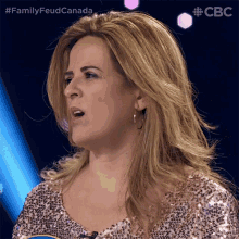 a woman in a sequined top is on a cbs show