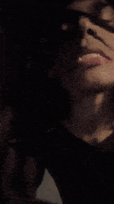 a close up of a person 's mouth with a black shirt on