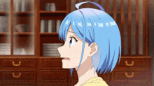 a girl with blue hair looks surprised in front of a cabinet