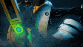 a close up of a robot 's head with a green light on it .
