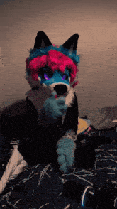 a person in a furry costume with a pink and blue wig