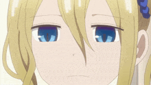a close up of a girl 's face with blonde hair and blue eyes