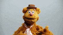 a teddy bear wearing a hat and a tie