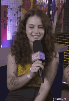 a woman is holding a microphone that says multi show on it