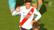 a soccer player wearing a turkish airlines jersey celebrates