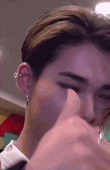 a close up of a person 's ear with a piercing