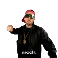 a man wearing sunglasses and a dollar sign necklace with mcdh written on his shirt