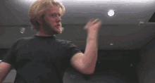 a pixelated image of a man with a beard pointing