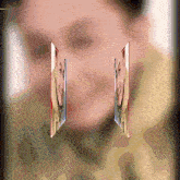 two images of a woman 's face are displayed on a blurred background