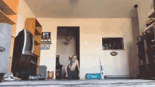 a man is standing in a living room with a sign that says pacific