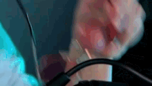 a close up of a person holding a cord