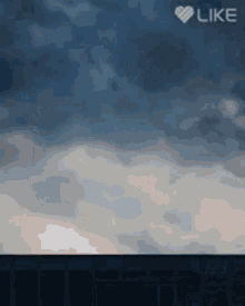 a blue sky with clouds and the word like on the bottom